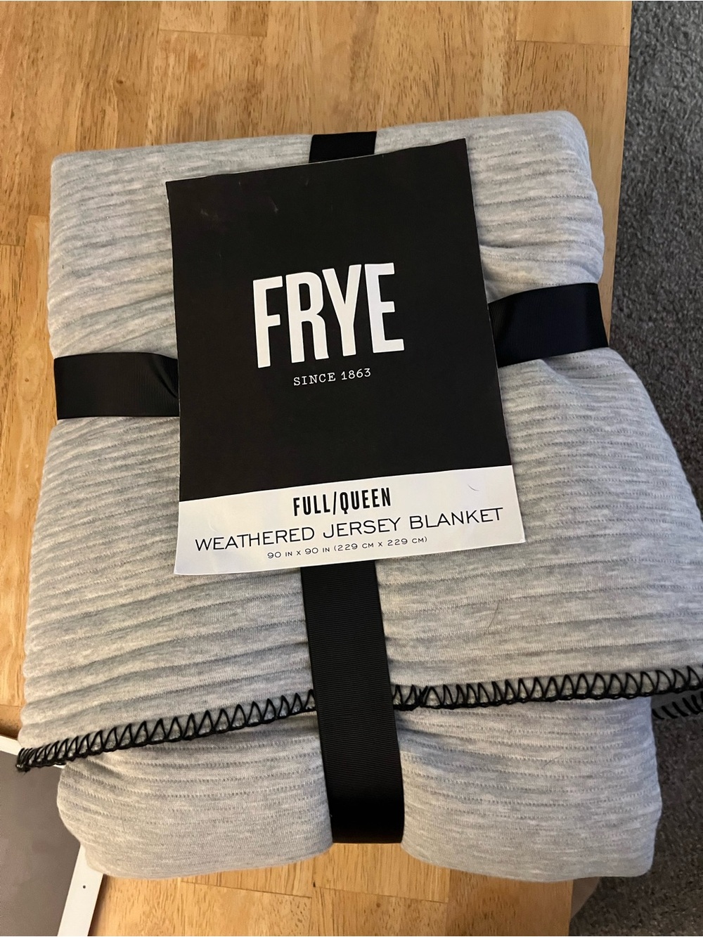 Brand new Frye Light Gray Weathered Jersey Throw with Black Whipstitch trim